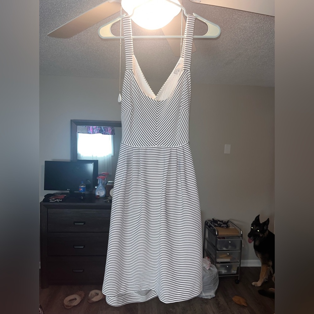 Small white dress with black stripes. Crossed strap back